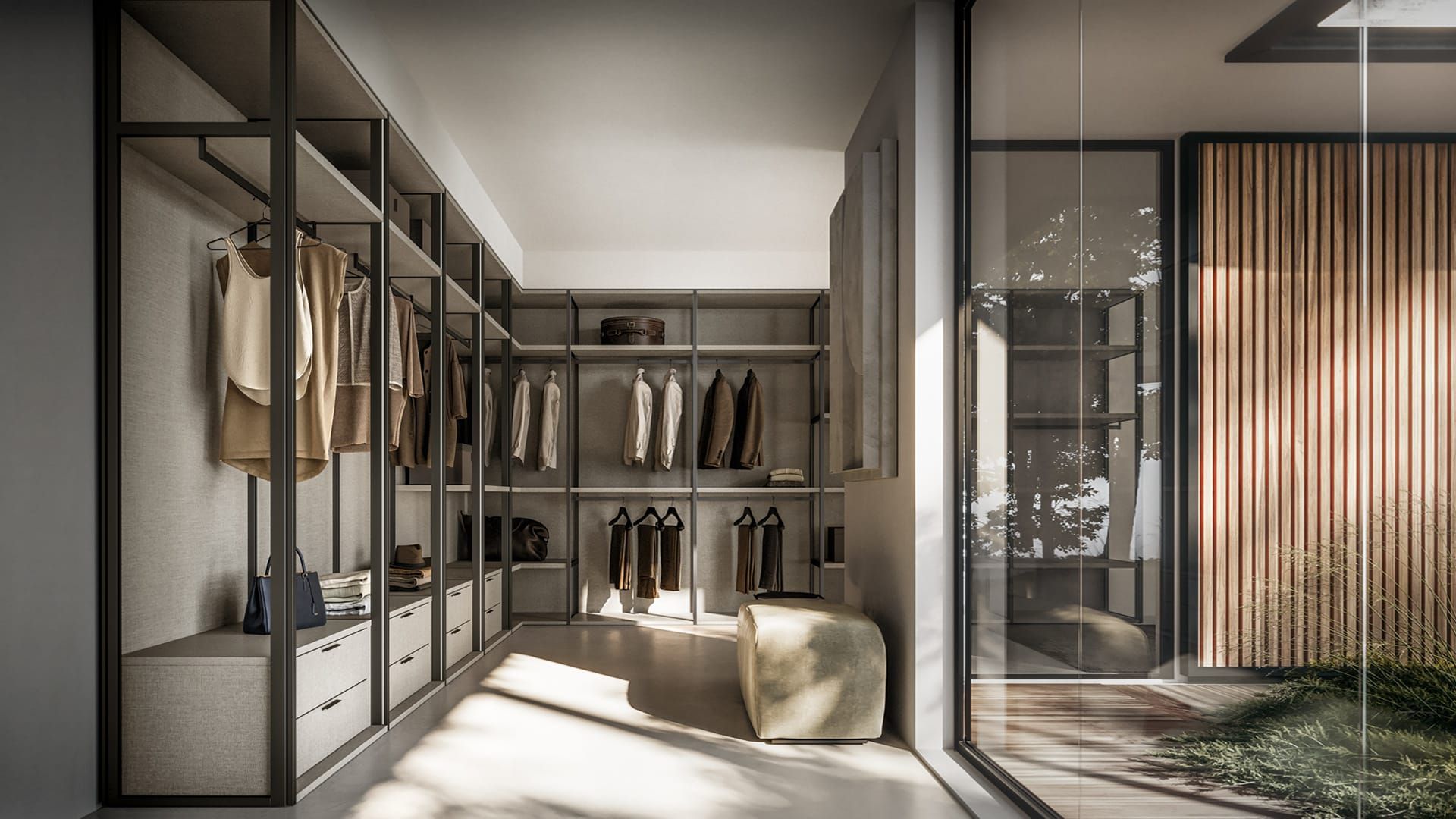 Cabina armadio moderna con ante in vetro, abiti appesi e luce naturale su una panca beige.
