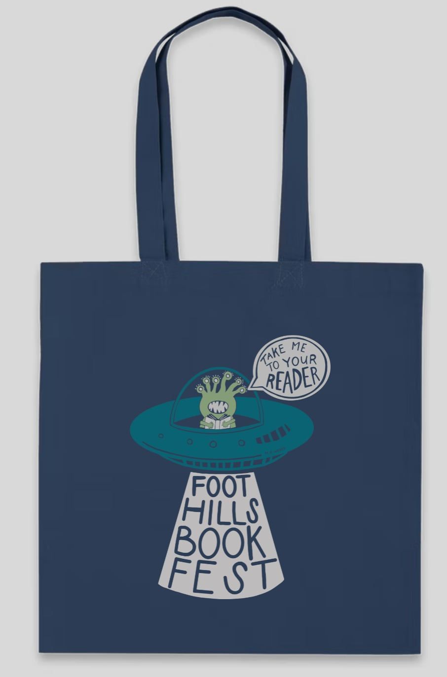 Navy tote bag with long handles and a Foot Hill Book Fest graphic in teal and white.