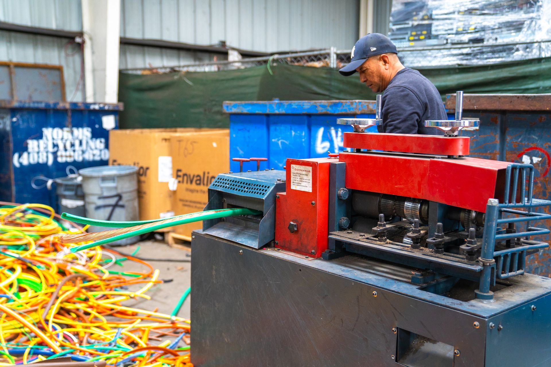 A man is working on a machine in a warehouse.