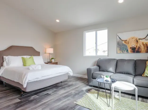 A bedroom with a king size bed and a couch.