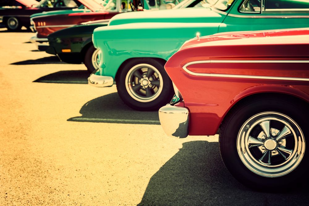 Row of Colorful Classic Cars at an Outdoor Car Show — Bundaberg Radiator and Mechanical Service in Bundaberg East, QLD