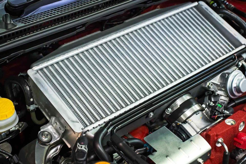 Intercooler Installed on a Car Engine, Silver Radiator — Bundaberg Radiator and Mechanical Service in Bundaberg East, QLD