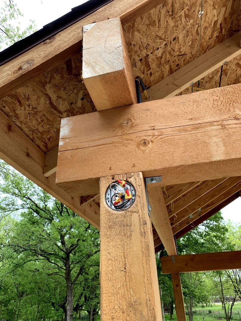 Wooden pavilion beam and post with a circular sticker under the roof outdoors