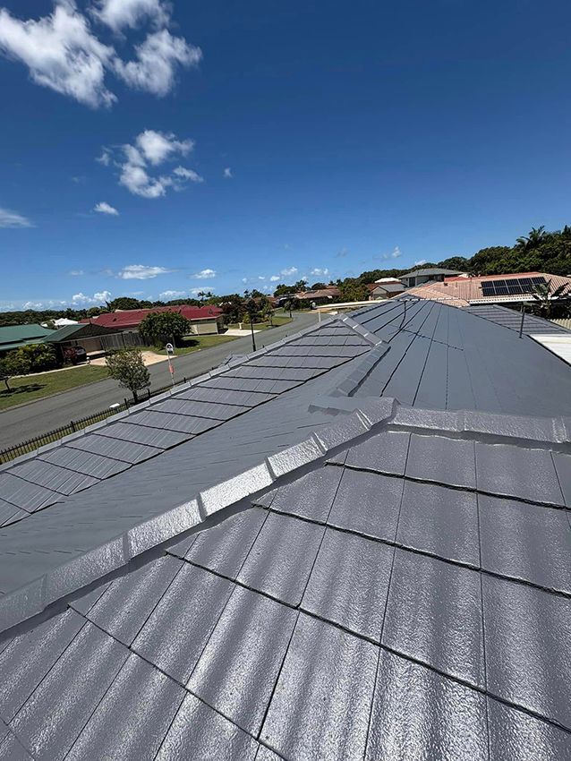 A Close Up of a Roof with a Blue Sky in the Background — Boss Roof Tiling and Restoration in Caboolture, QLD