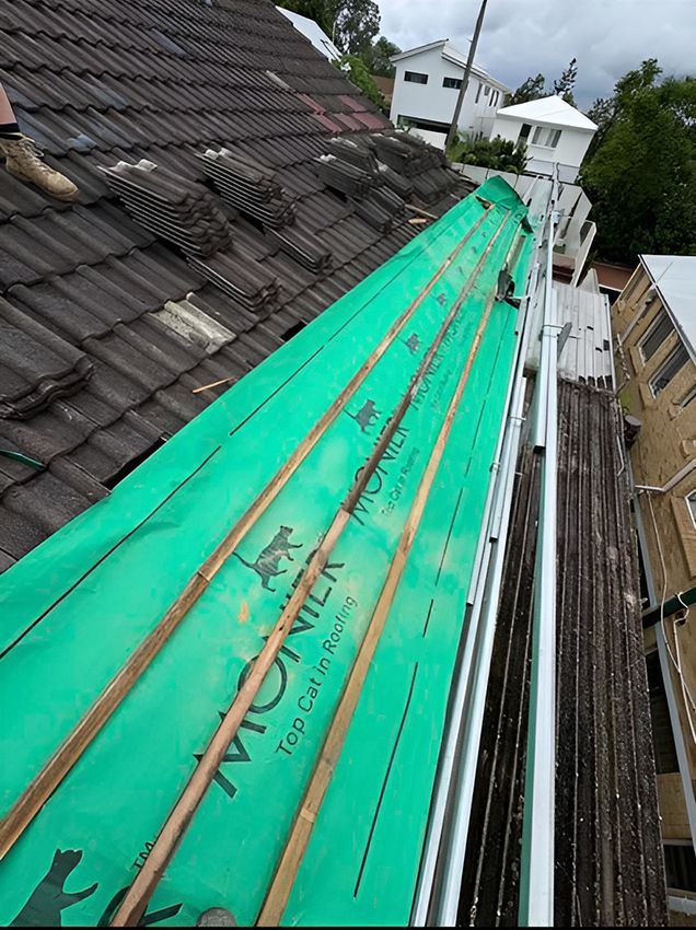 The Roof of a Building is Covered with a Green Tarp — Boss Roof Tiling and Restoration in Caboolture, QLD