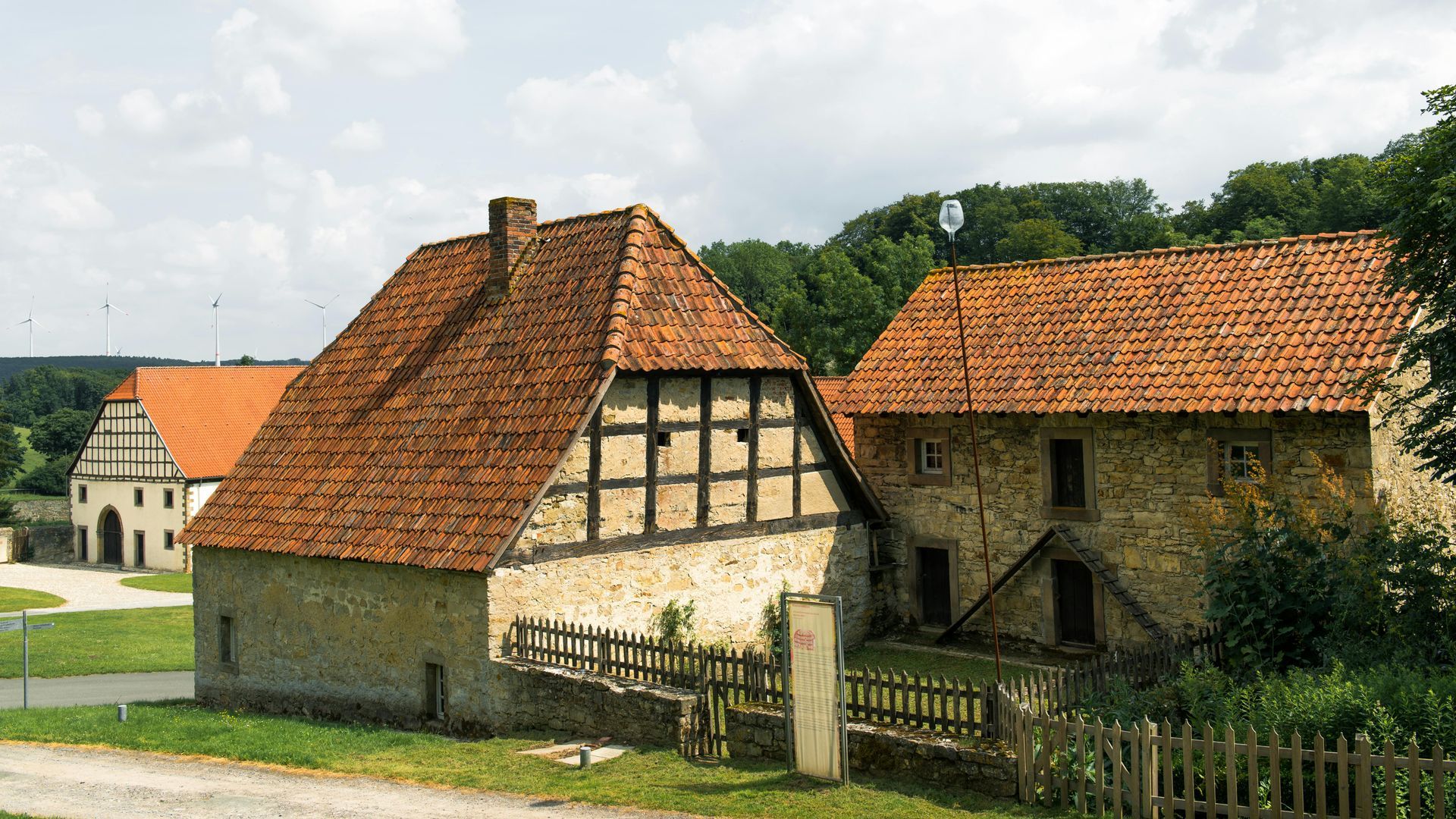 Thatched-roof rural houses with half-timbered walls in a village setting