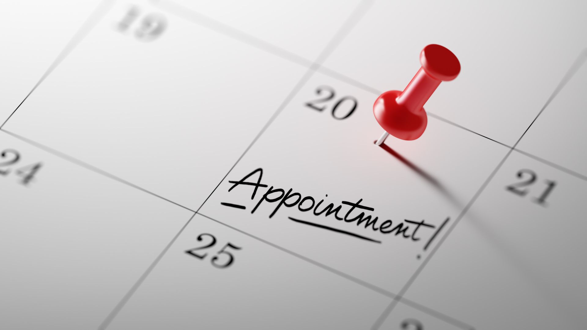 Red pushpin marking “Appointment!” on a calendar page