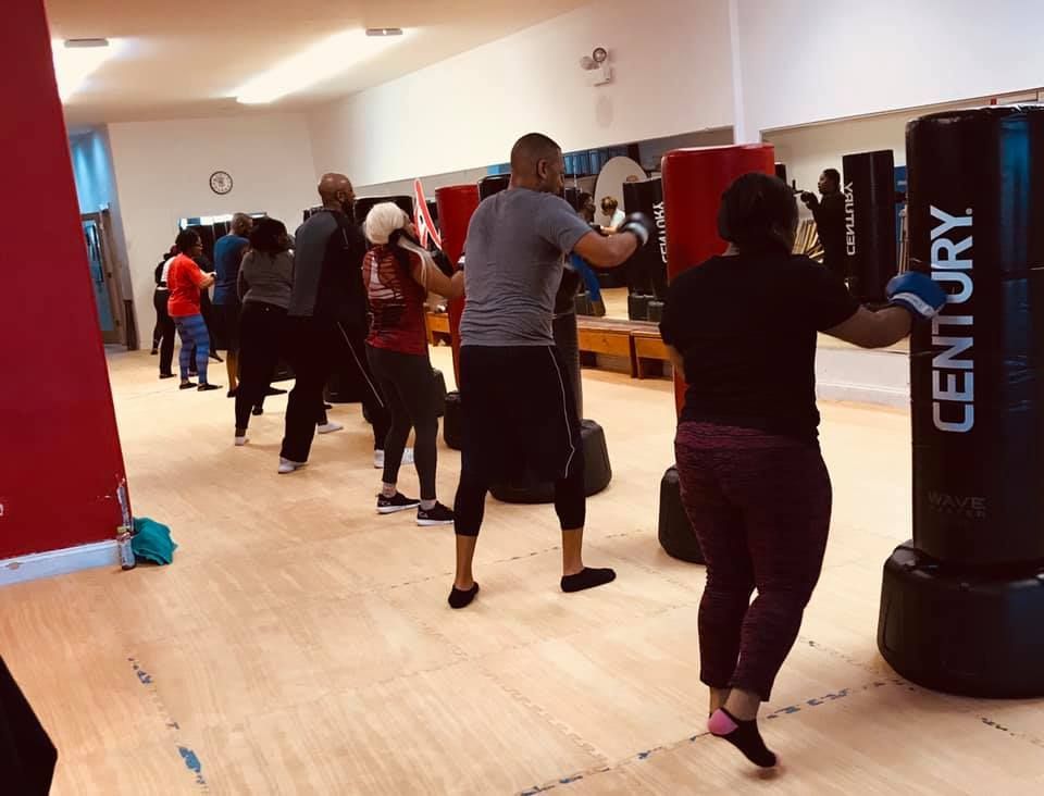 A group of people are boxing in a gym.