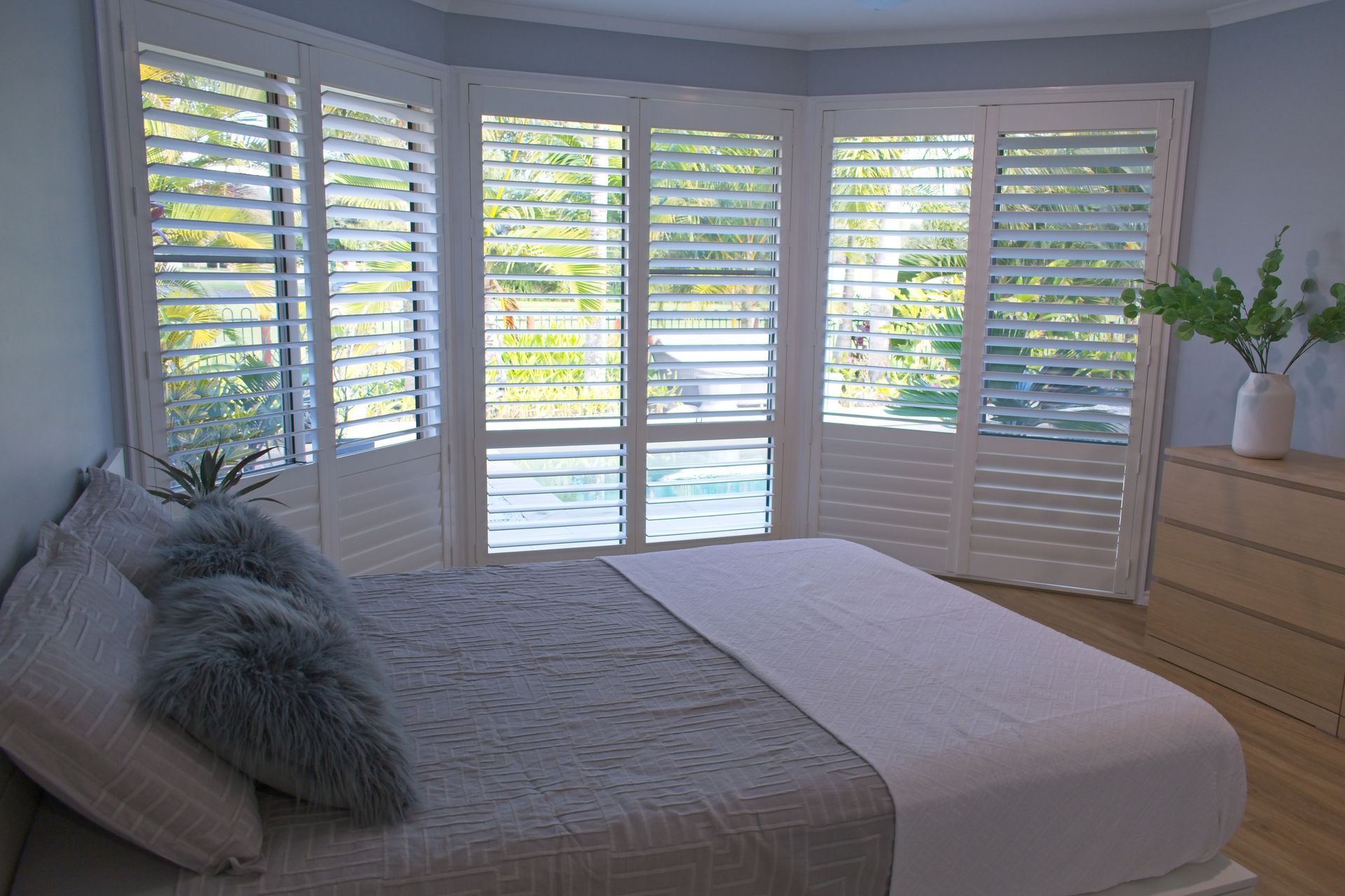 Luxury plantation shutters in bedroom.