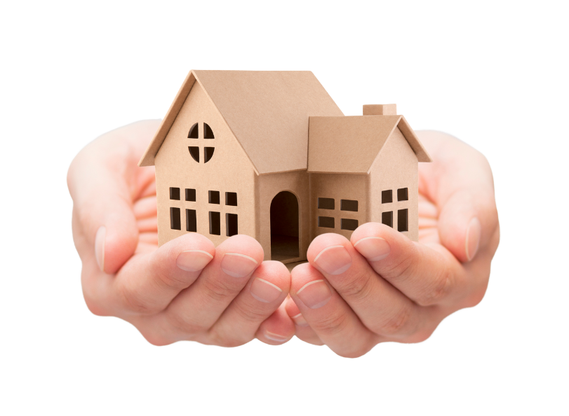 Hands cupping a small, cardboard house, suggesting care and protection.