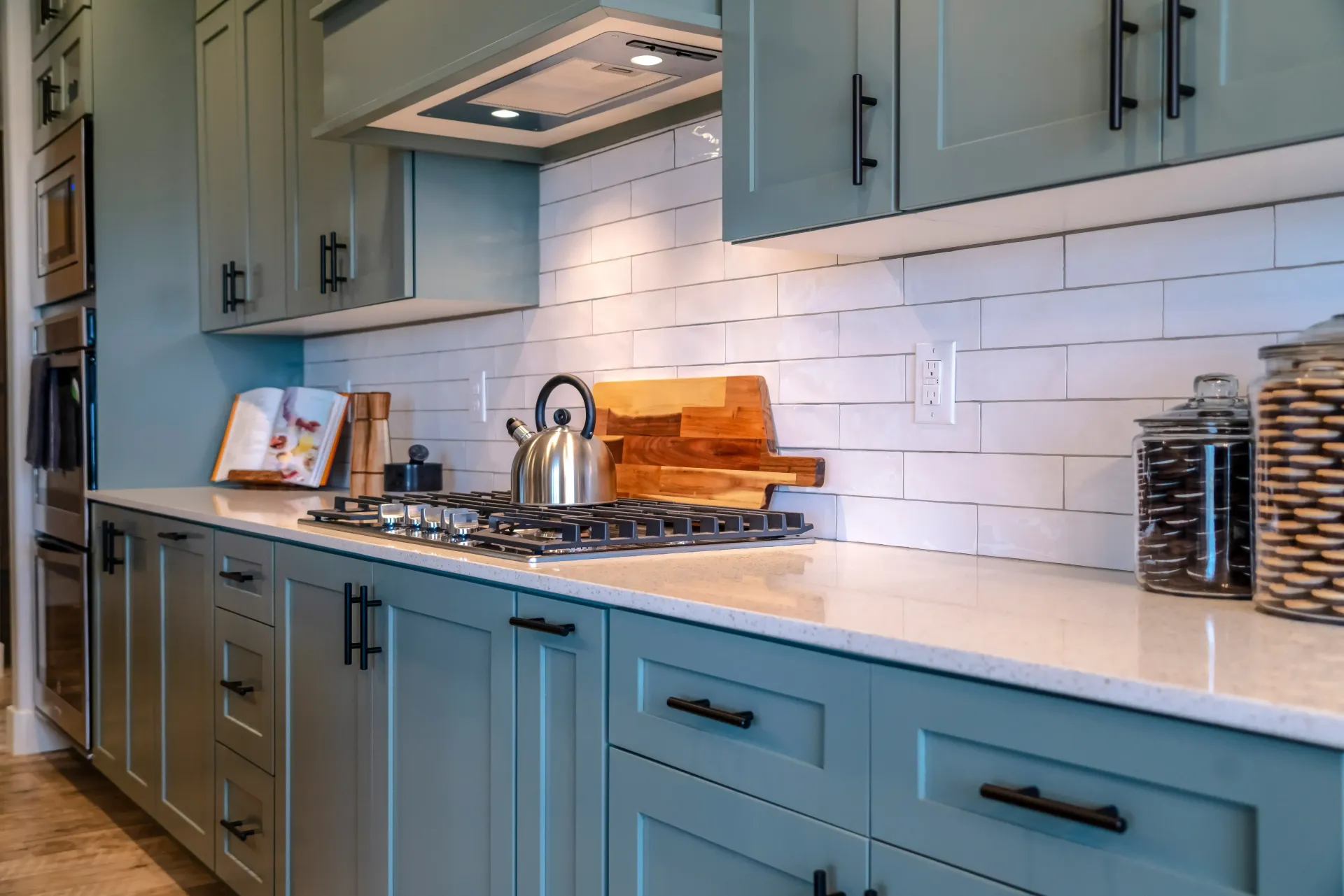 this is a kitchen tile setup with backsplash tile in between blue cabinets