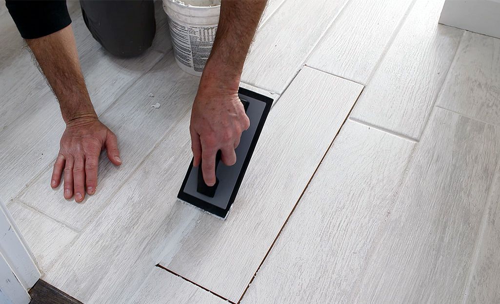 this is an image of a technician fixing accent tile