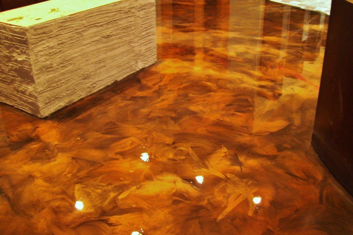 Wood-grain tabletop with a block of napkins and a dark drink glass at the edge