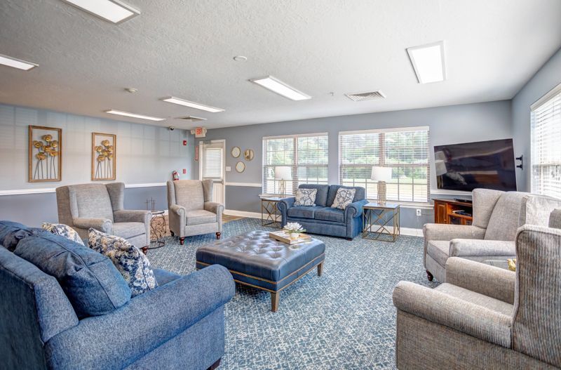 A living room filled with furniture and a television.
