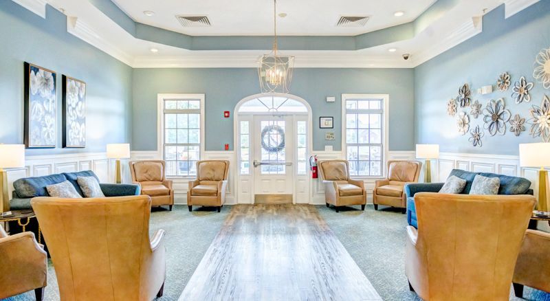 A large living room filled with furniture and a chandelier.