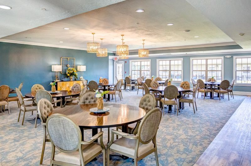 A large room with tables and chairs in it.