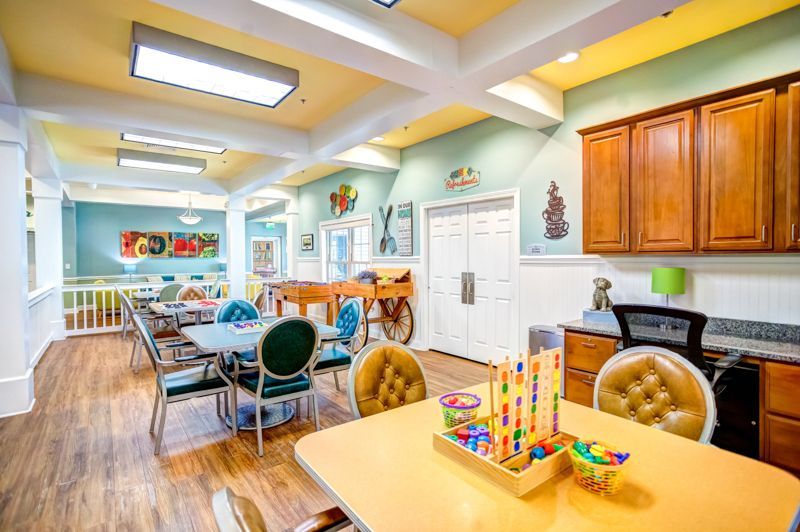 A large room with a table and chairs in it.