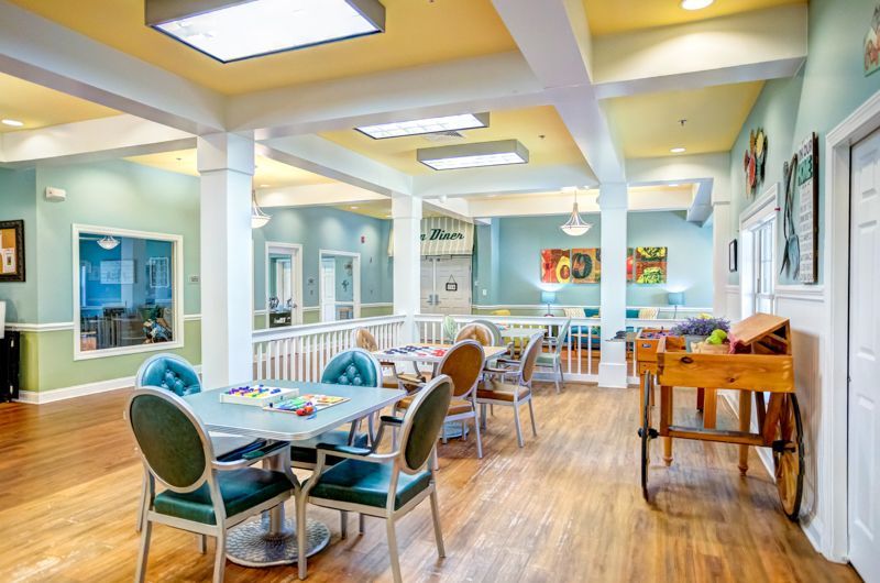 A large room with tables and chairs in it.