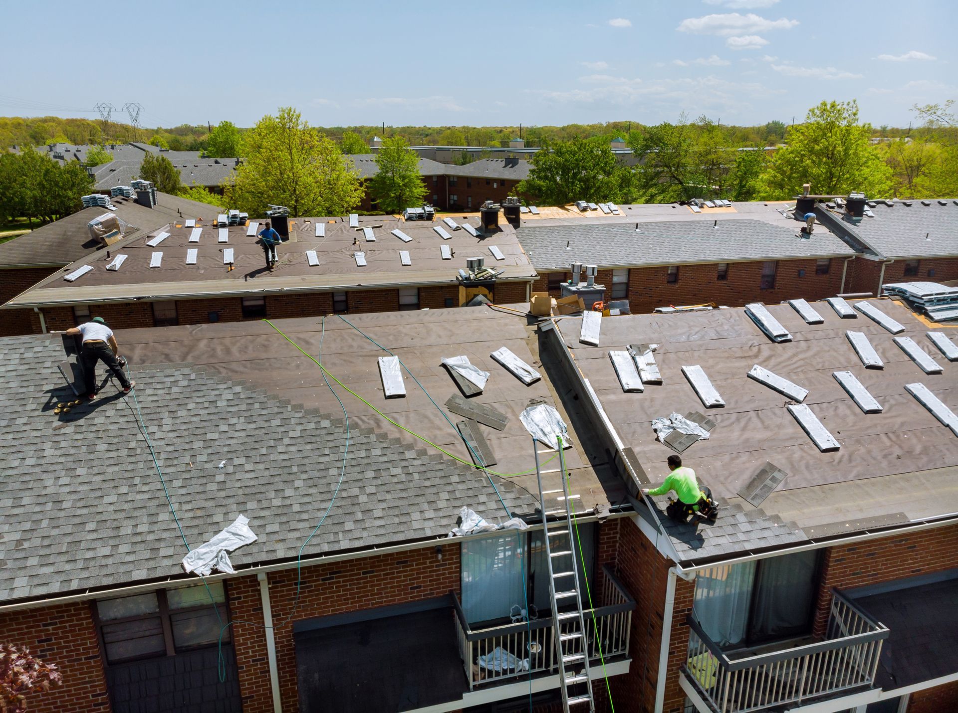 Professional Workers Installing New Shingles for Residential Roof