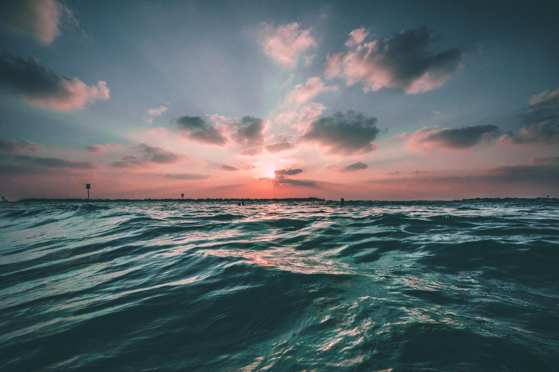 The sun is setting over the ocean.