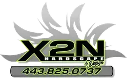 Logo for X2N Hardscape & Design with phone number. Green and black text on a gray backdrop.