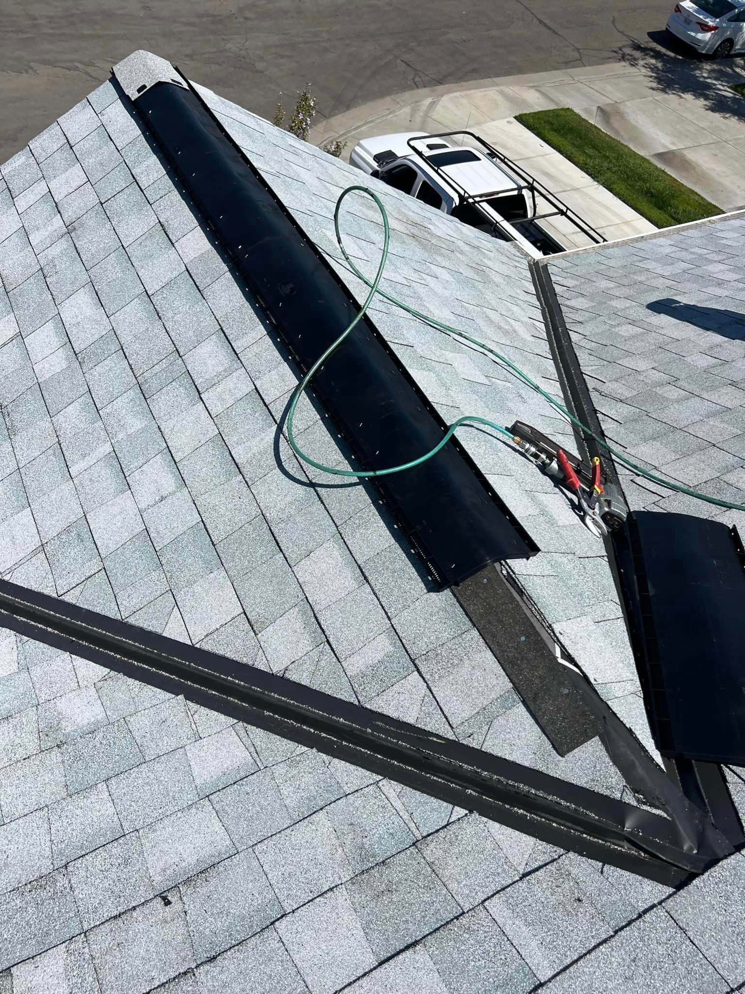 A close up of a roof with a hose attached to it.
