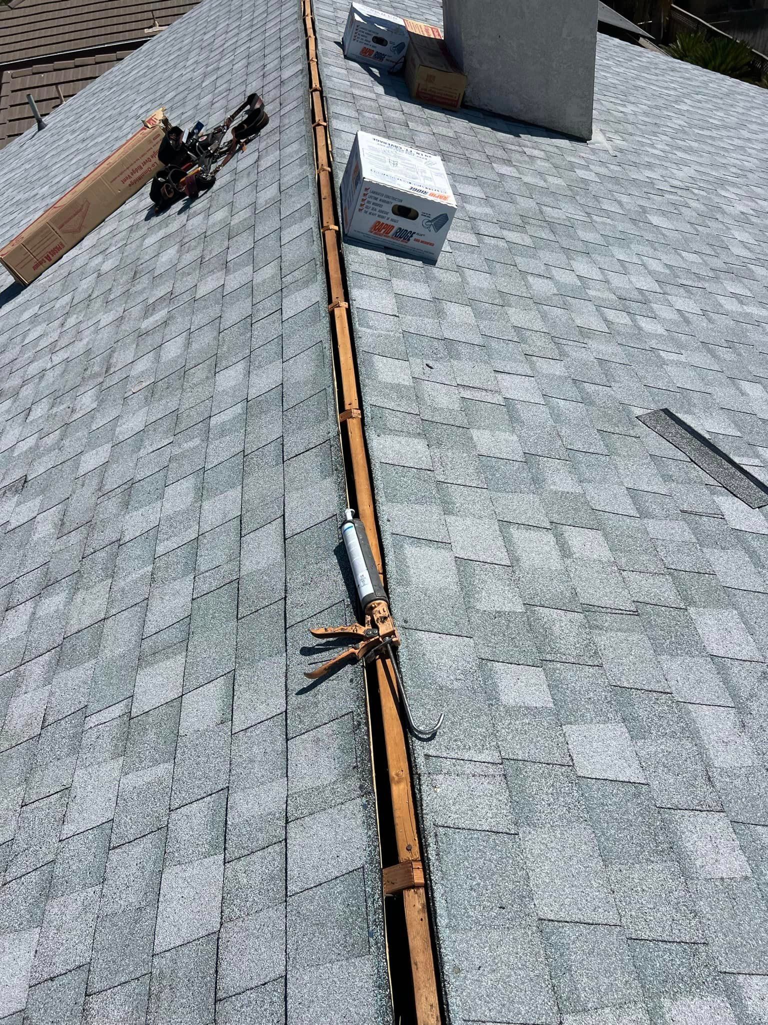 A roof with a chimney and a box on top of it.