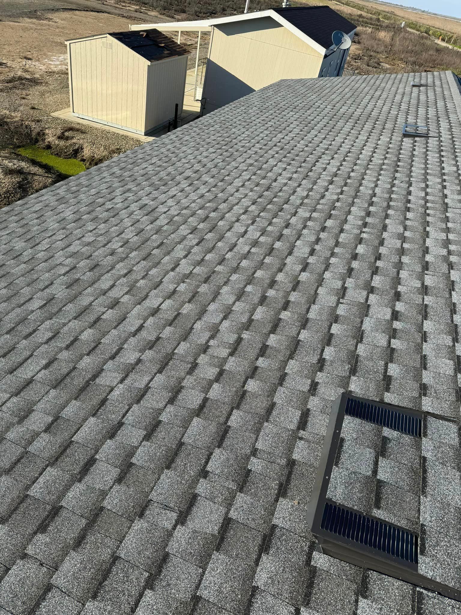 A roof with a lot of tiles and a ladder on it.