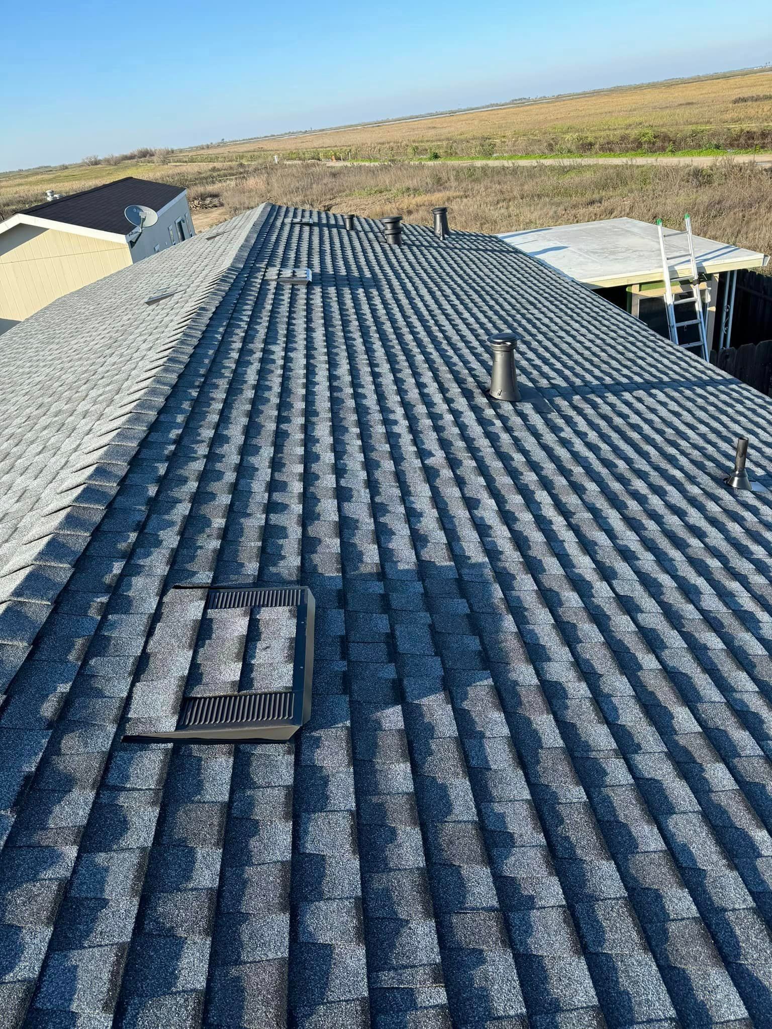 A close up of a roof with a skylight on it.