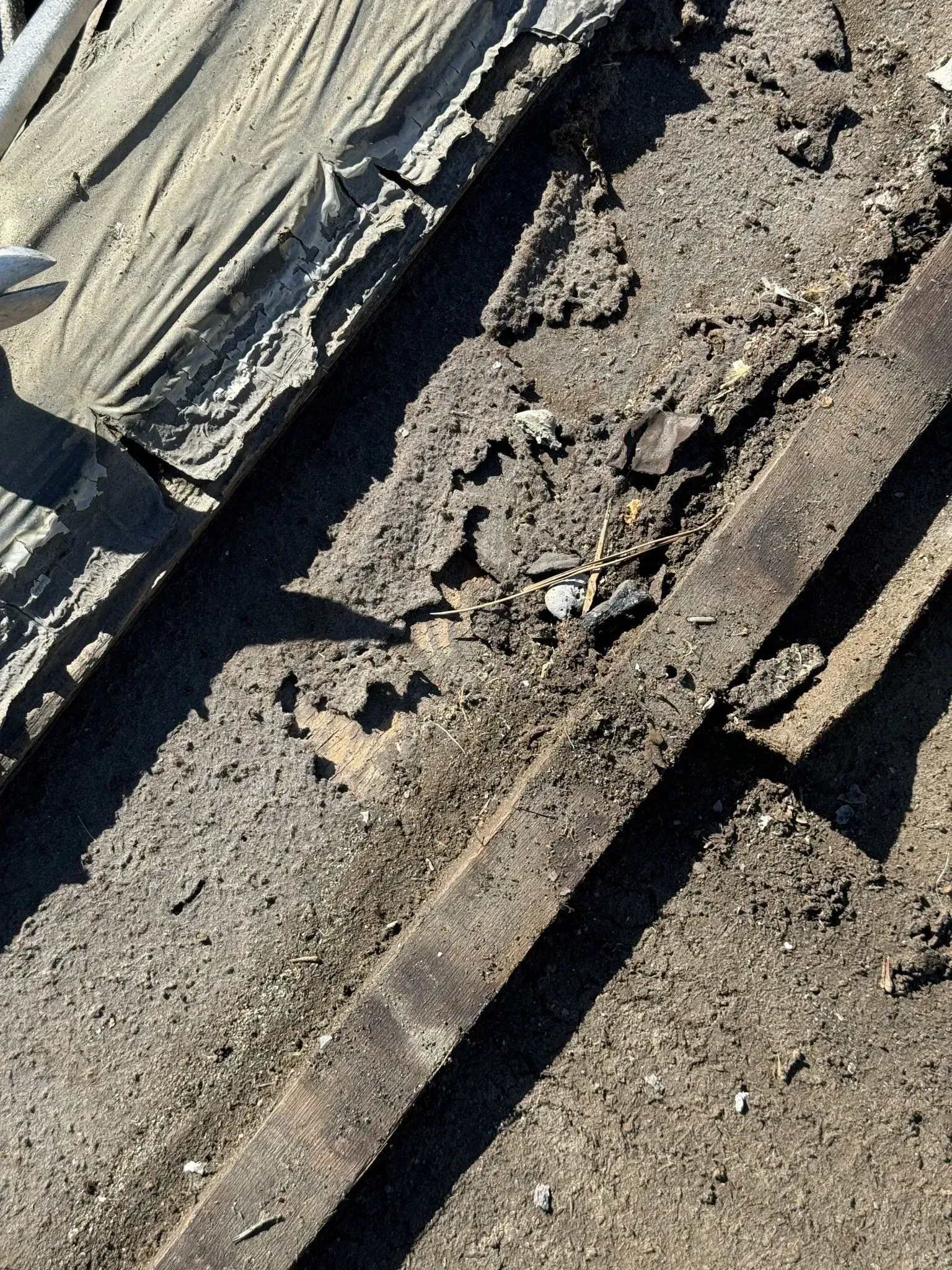 A close up of a roof with a lot of dirt on it.