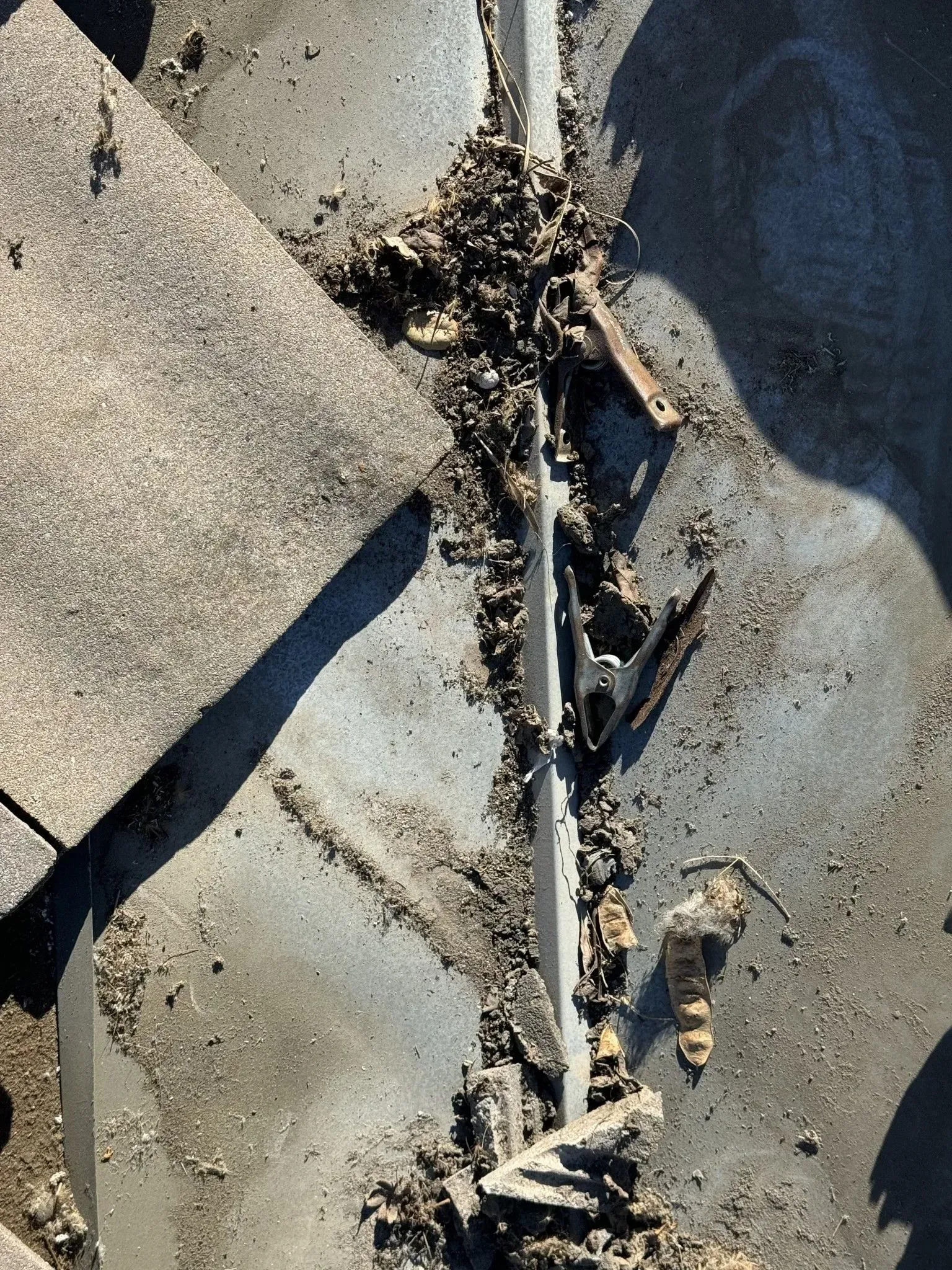 A close up of a roof with a lot of dirt on it.