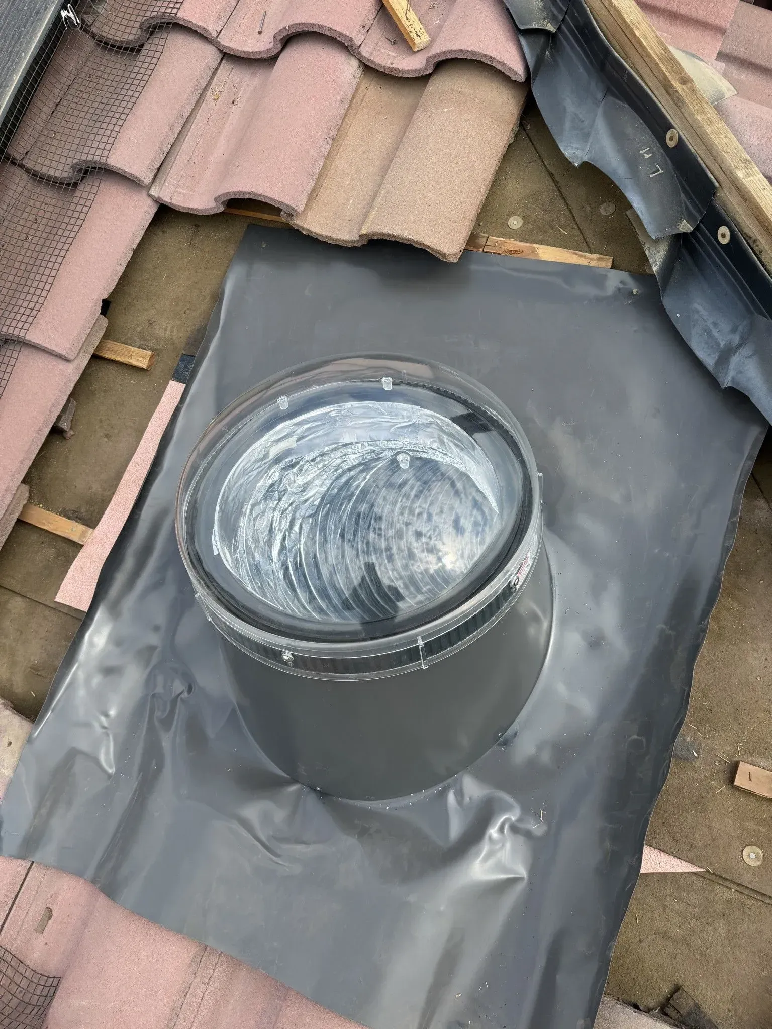 A skylight is being installed on the roof of a house.