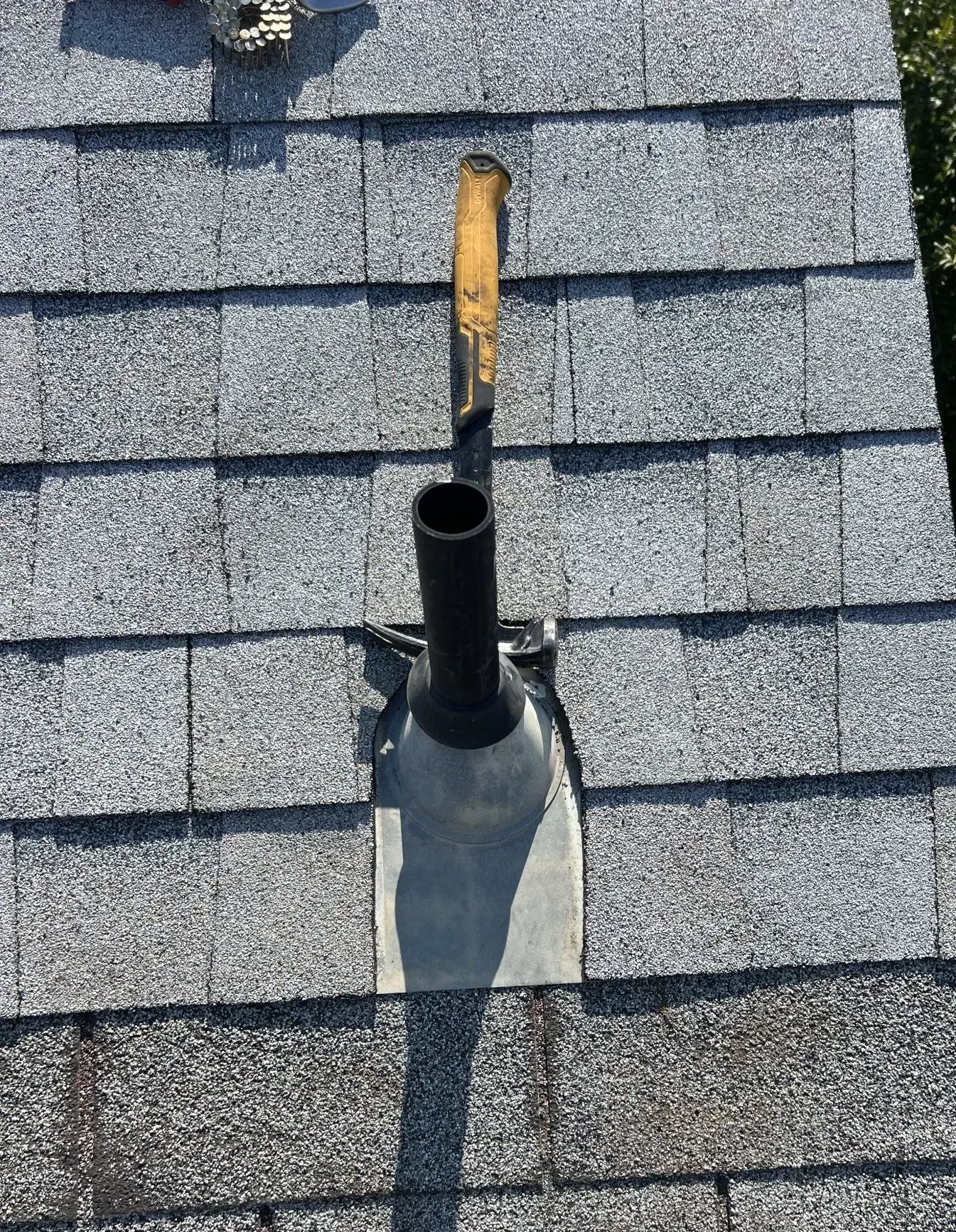 A roof with a hole in it and a chimney on it.
