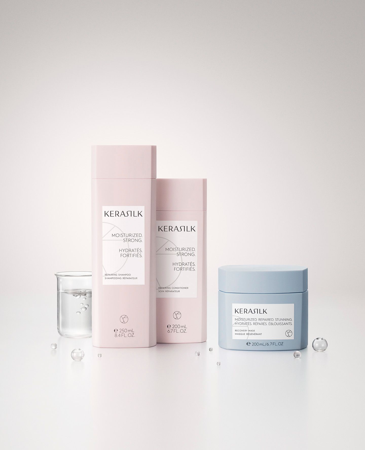 Skincare products, pink and blue packaging. Bottles and jar on white surface — Clippers Hair Salon in Taree, NSW