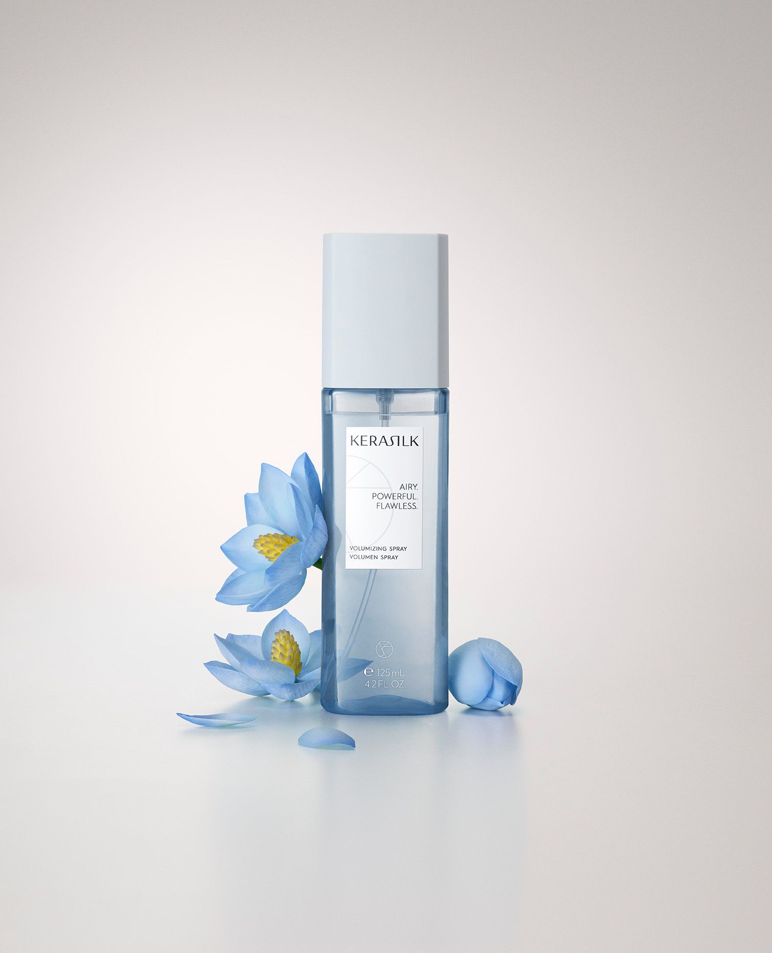 Bottle of facial toner with blue flowers on white background — Clippers Hair Salon in Taree, NSW