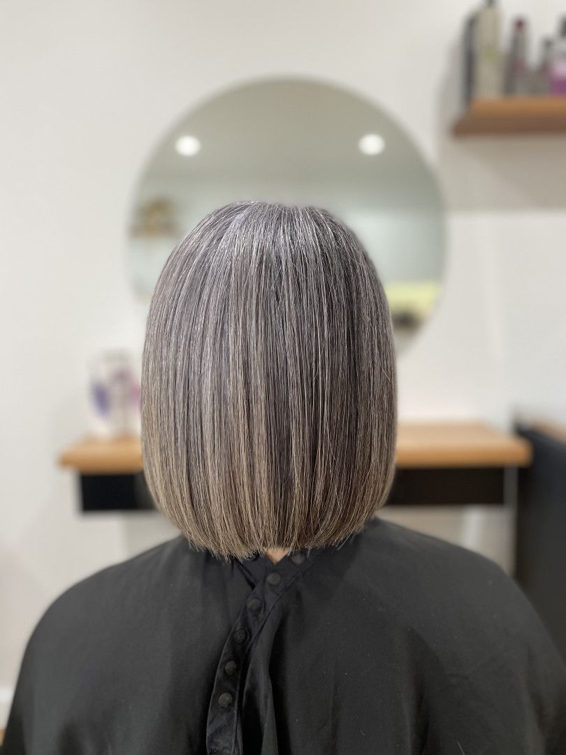 Back view of a person with straight, short, graying hair, in a salon — Clippers Hair Salon in Taree, NSW