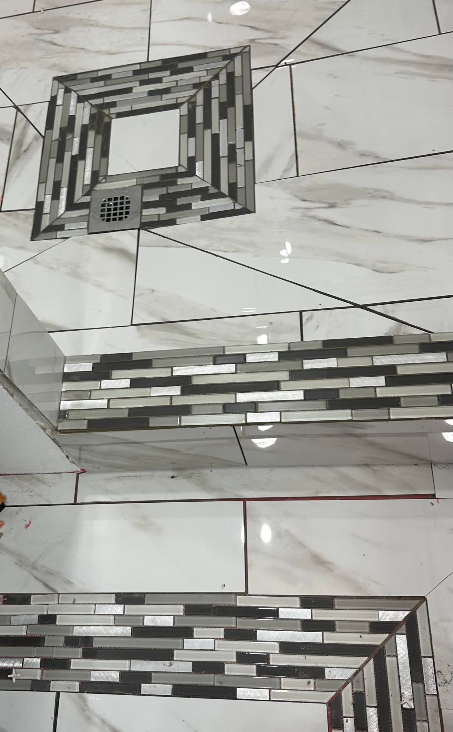 Abstract geometric wall tile pattern in gray, white, and black with mirrored square motifs