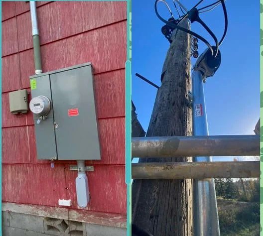Gray electrical meter box on red siding; utility pole with wires against blue sky.