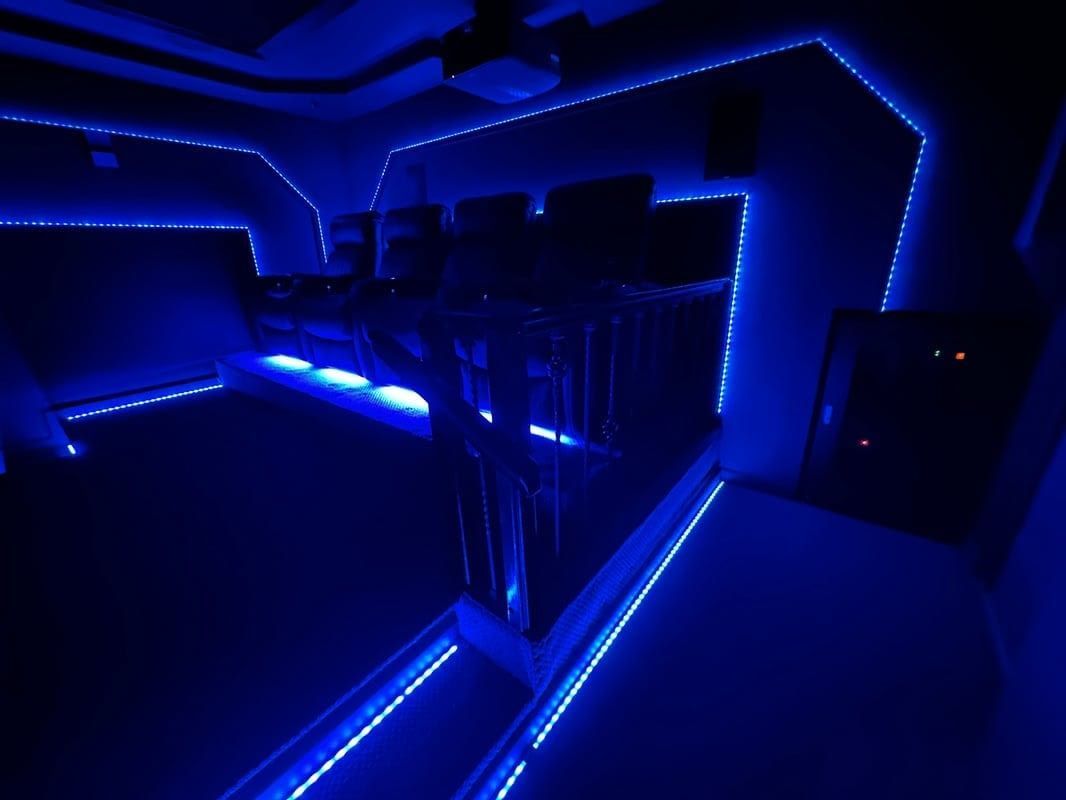 Blue neon-lit interior with glowing LED strips and dark reflective surfaces
