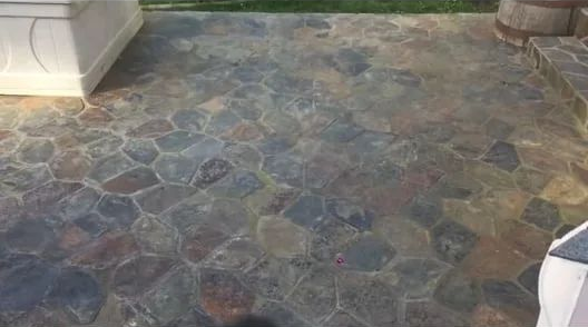 Stone-patterned outdoor patio floor in mixed gray, brown, and blue tones.
