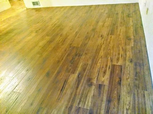 Empty room with glossy wood flooring and white walls