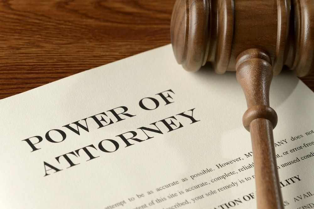 A Wooden Gavel Is Sitting on Top of A Power of Attorney — Linda Emery & Associates In Gosford, NSW