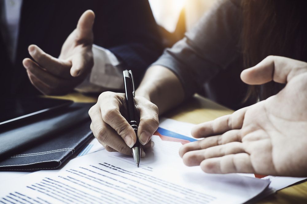A Person Is Writing on A Piece of Paper with A Pen  — Linda Emery & Associates In Umina Beach, NSW