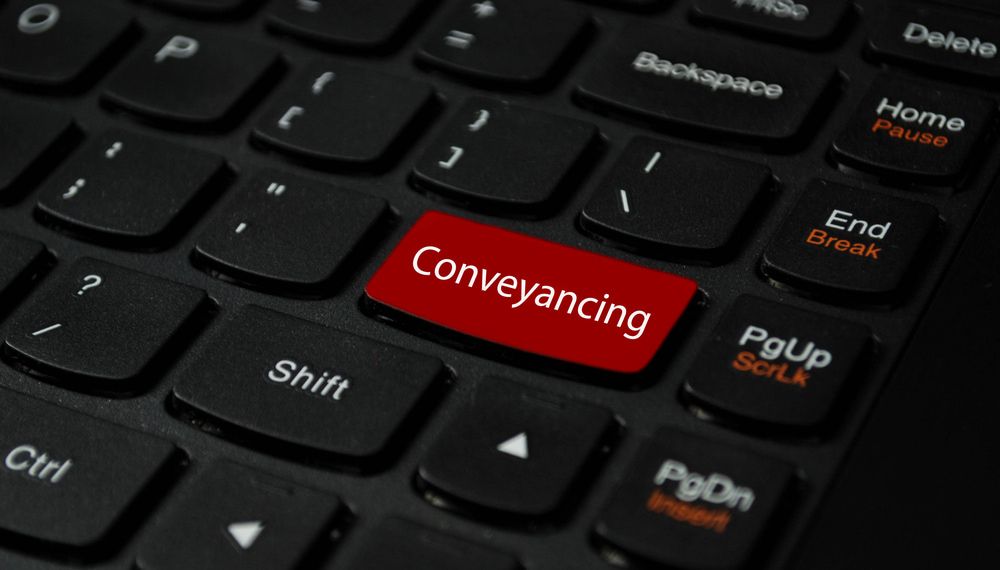 A Black Keyboard with A Red Button that Says Conveyancing — Linda Emery & Associates In Erina, NSW