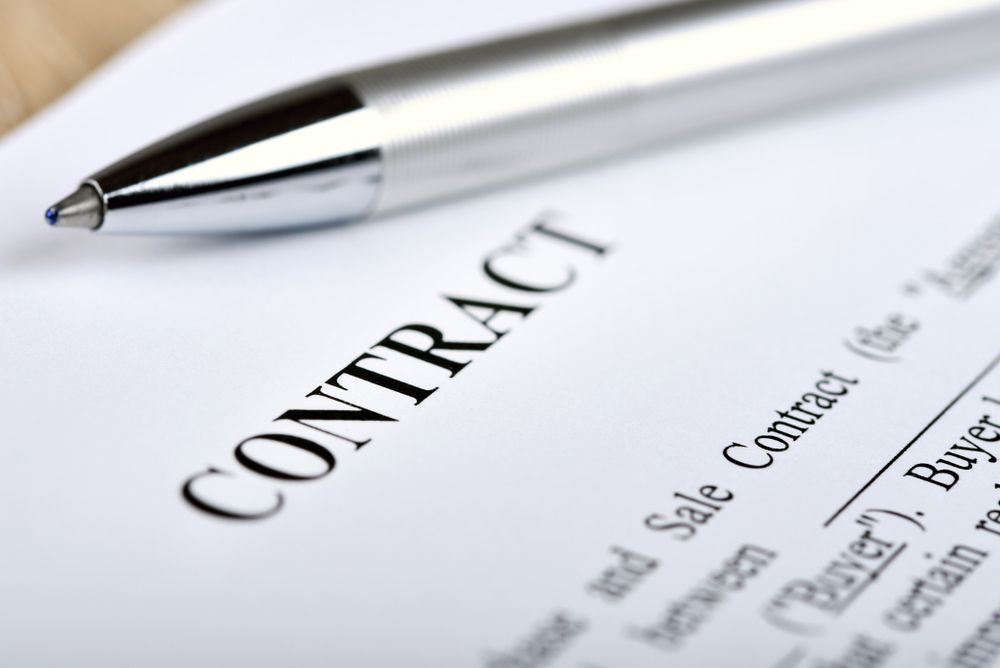 A Pen Is Sitting on Top of A Contract — Linda Emery & Associates In Erina, NSW