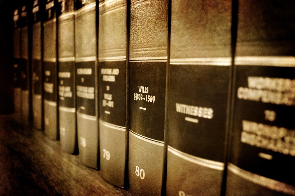 A Row of Law Books Are Lined up On a Shelf — Linda Emery & Associates In Woy Woy, NSW