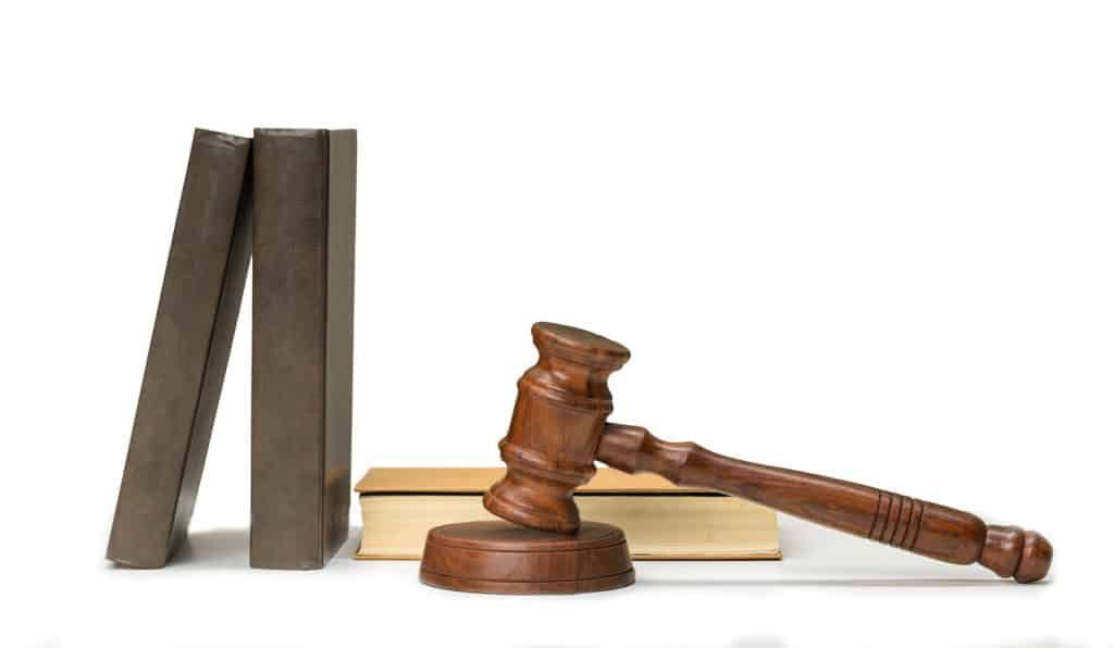 A Wooden Judge 's Gavel Is Sitting on Top of A Book — Linda Emery & Associates In Gosford, NSW