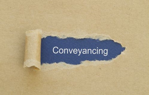 A Piece of Torn Paper with The Word Conveyancing Written on It — Linda Emery & Associates In Wyong, NSW