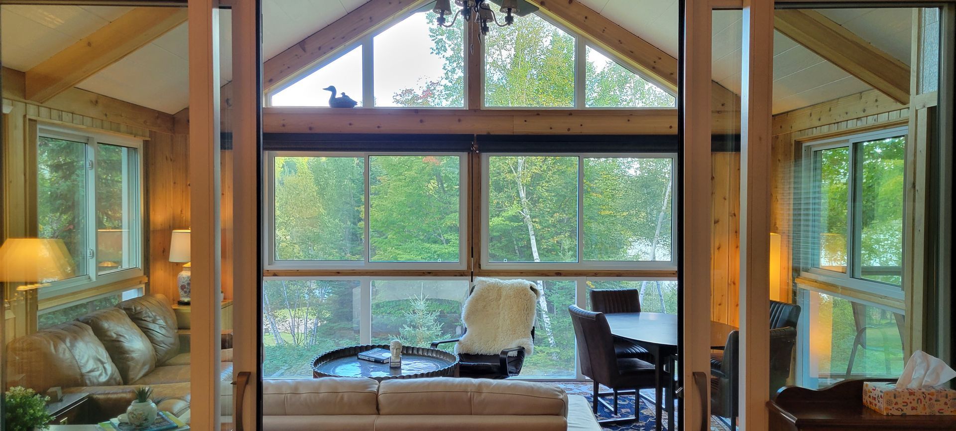 A living room with a lot of windows and a couch.