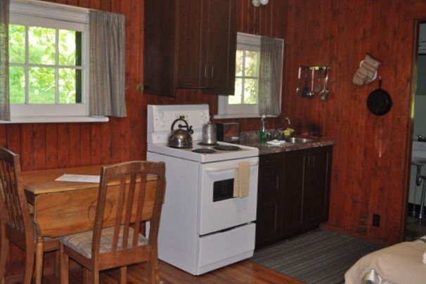 A kitchen with a table and chairs and a stove